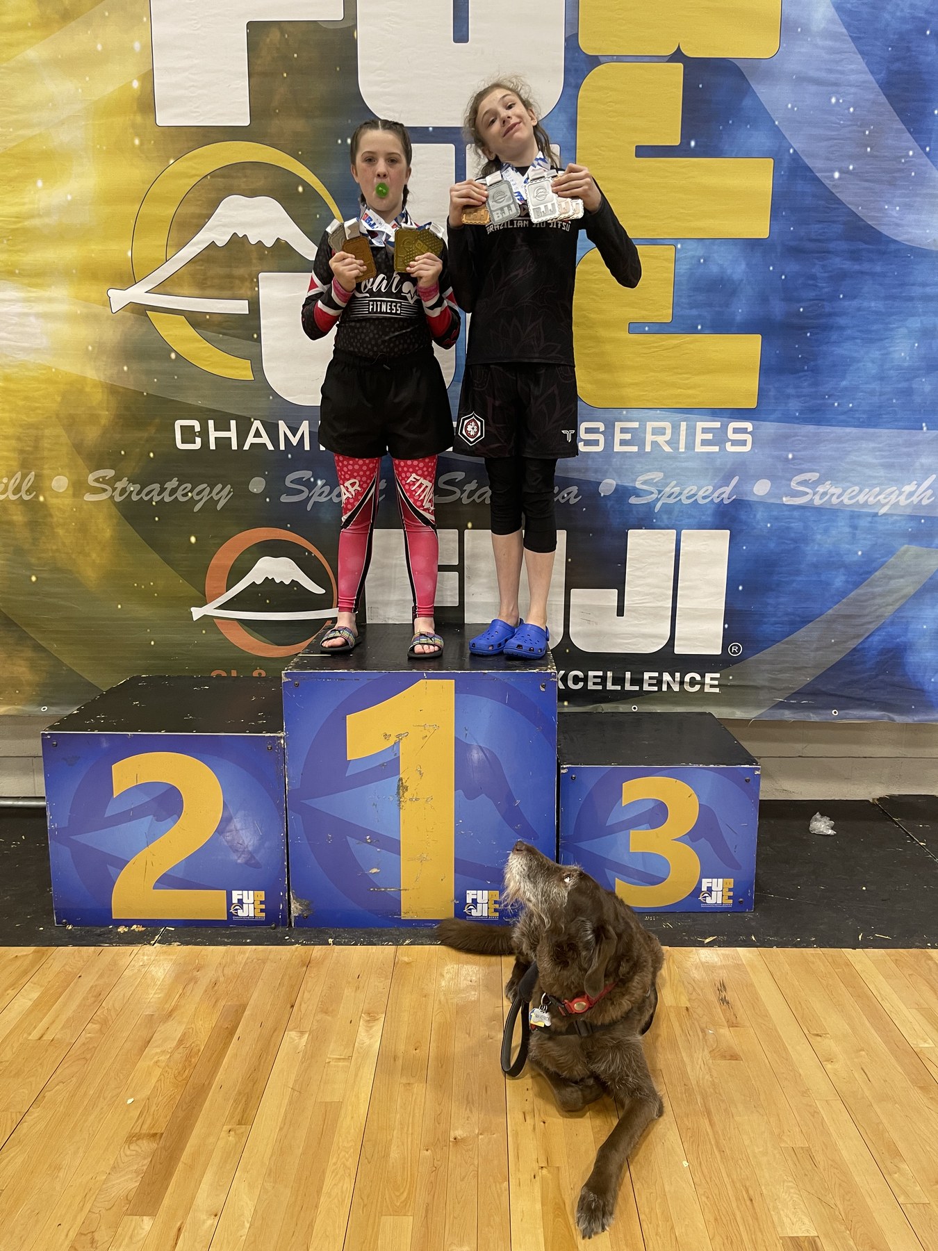 Miley and a teammate on the podium with Maverick seated in front